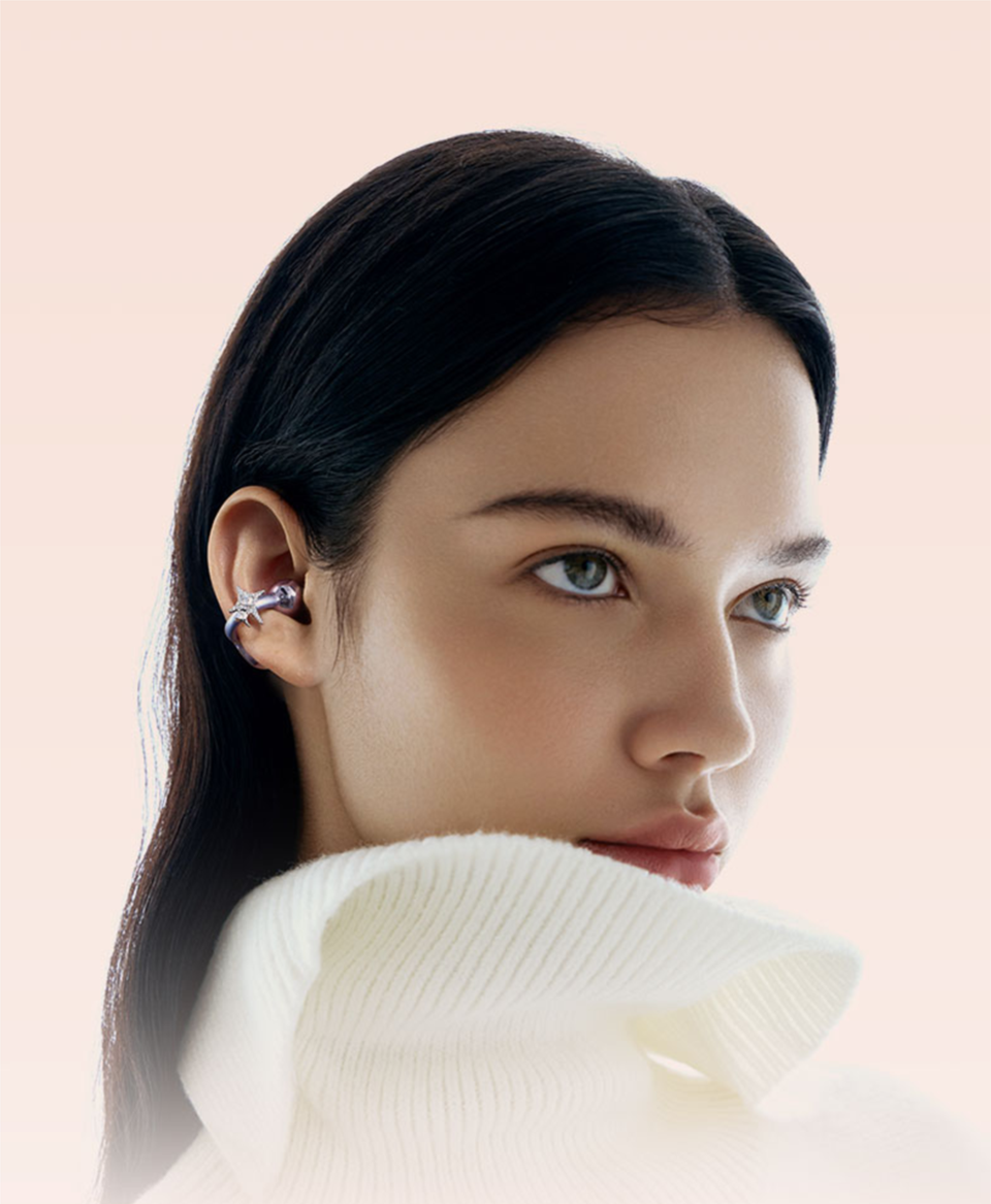 Woman wearing SANAG S6S Nova purple earphone with crystal star accessory like jewellery